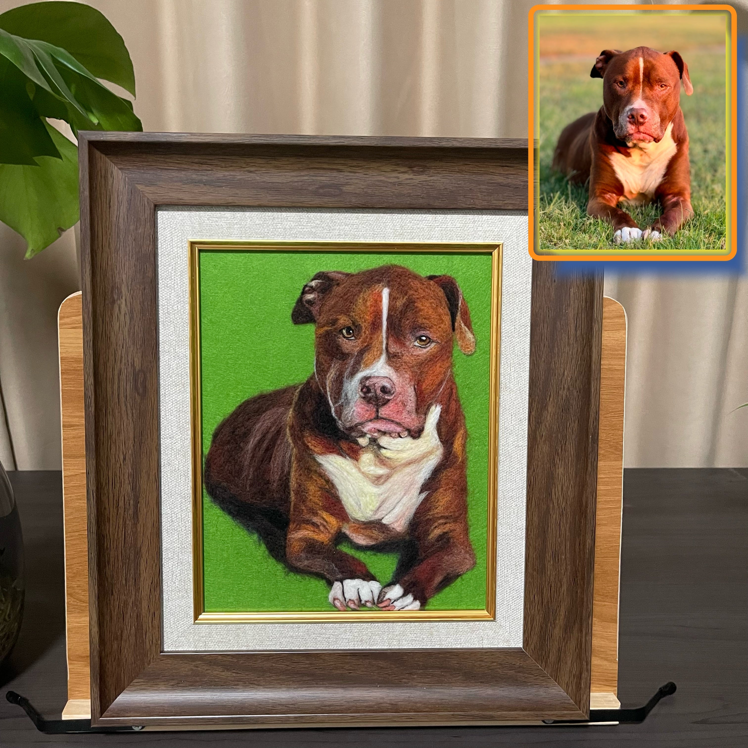 Framed portrait of a brown and white dog on a green background, with a smaller inset photo of the same dog outdoors.